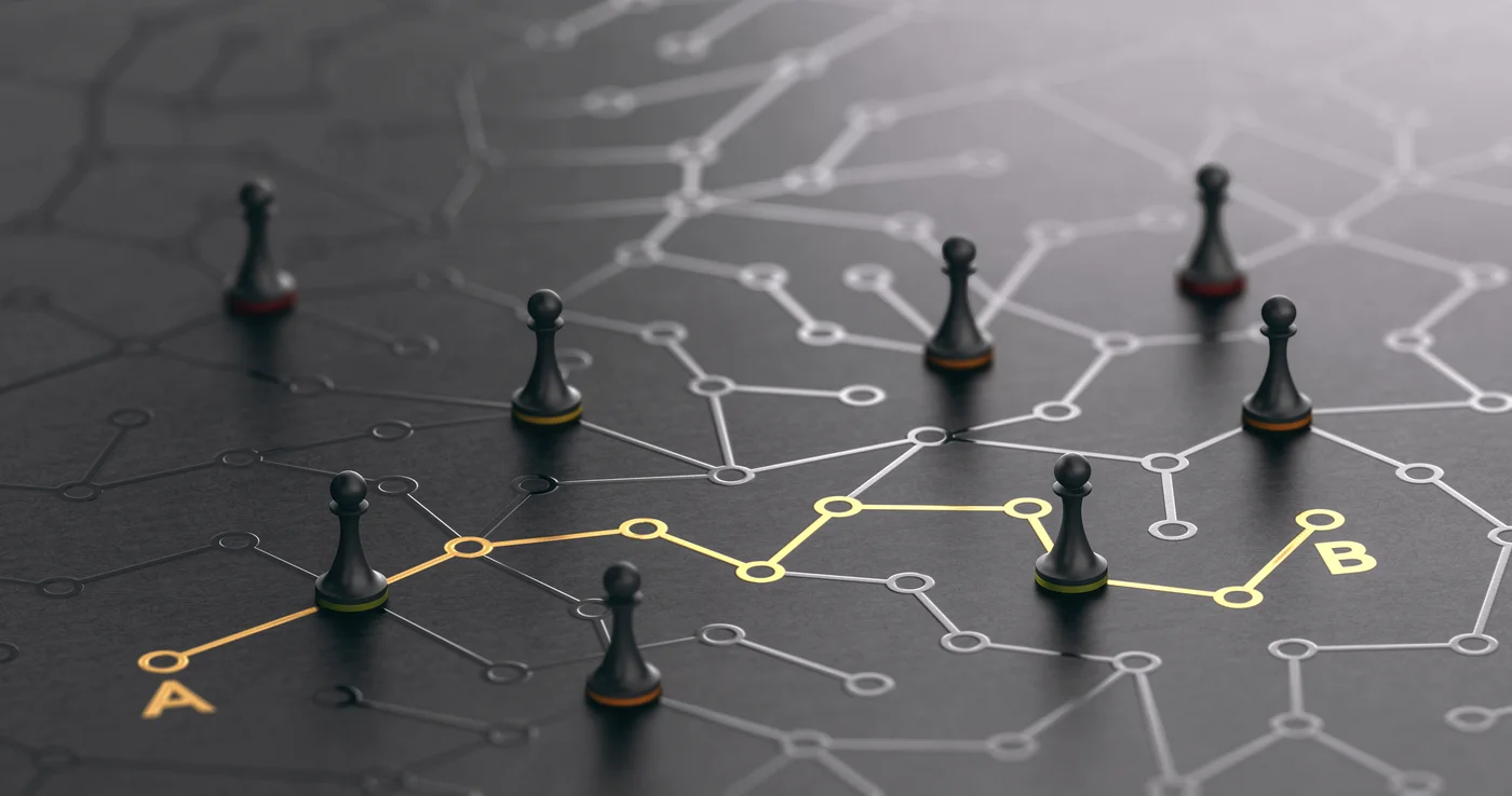 Scattered chess pawns on a dark surface connected by a network of pathways, with a single highlighted route linking a starting point A to an endpoint B